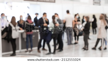 Abstract blured people at exhibition hall of expo event trade show. Business convention show or job fair. Business concept background.