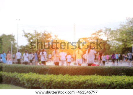 abstract blurred of Aerobic exercise in the public park with sunlight