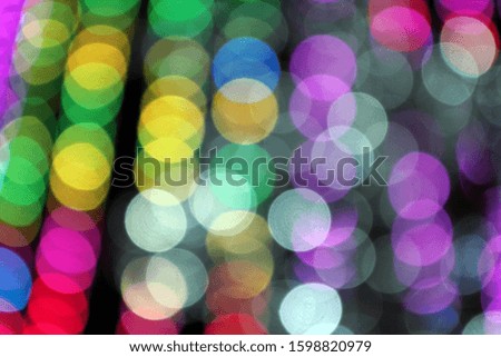 Abstract blurred background. Blurry lights. Blurry garland with multicolored lights. Multicolored toning. Christmas coming concept.
