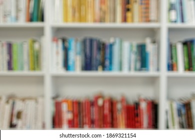 Abstract Blurred Background Of Bookshelves With Books At Home Library. Reading And Education Concept.