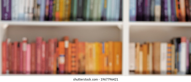 Abstract Blurred Background Of Bookshelves With Books At Home Library. Reading And Education Concept.