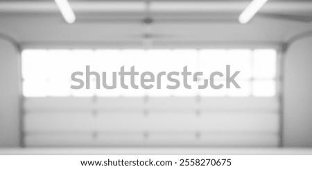 Abstract blurred background of a bright, spacious garage interior.