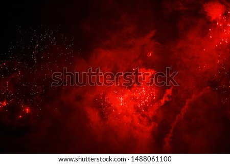 abstract blurred background.
celebration. new Year. salute. sparks from fireworks on a background of red haze. looks like a universe