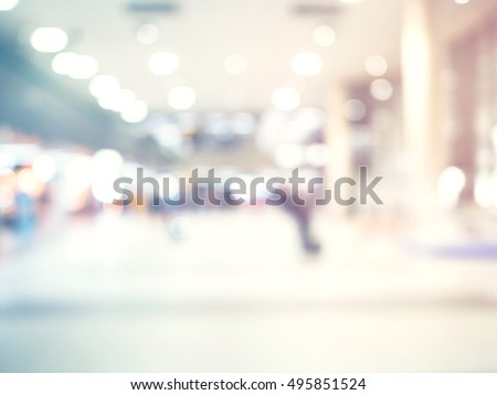 abstract blurred background : crowd people at terminal department at airport with bokeh light.