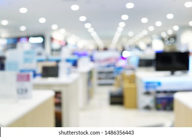 Abstract Blurred Background Of An Electronic Department Store Interior. Blur Aisle Of Supermarket Or Warehouse For Backdrop And Design Element Use. Defocused Background With Bokeh Light.