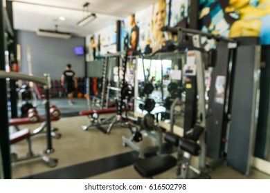Abstract blurred background of exercise equipments in modern fitness gym