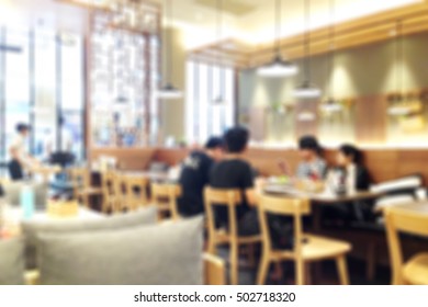 Abstract Blurred Background Of Family On Table With Ceiling Lamp In Modern Japanese Restaurant