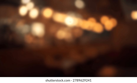 Abstract blurred background featuring soft golden bokeh light circles from interior lamps in a dark room setting