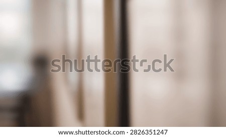 An abstract and blurred background featuring soft vertical lines and a gentle color palette, creating a serene and minimalist aesthetic.