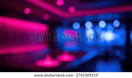An abstract and blurred background featuring the vibrant and dynamic atmosphere of a nightclub or bar, illuminated by striking pink and blue neon lights creating a captivating bokeh effect.