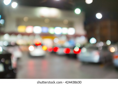 Abstract Blurred Background Of Outdoor Parking Lot In Fornt Of Building Night Time