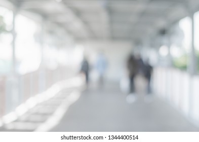 abstract blurred background outdoor walk way to shopping mall defocused depth white bokeh with customer walking in to hall of department store. - Shutterstock ID 1344400514