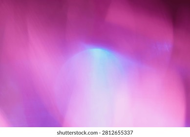 Abstract blurred background with a pink and purple color gradient. Dreamy out of focus petals with a bright highlight and light leak, creating an ethereal floral texture for romantic, creative designs