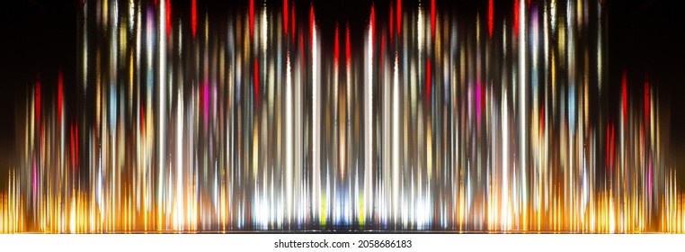Abstract blurred background with reflection of colorful lights in the water. Golden and red colors