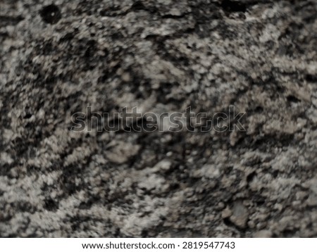 Abstract blurred background of rough stone wall wall texture with grey bokeh effect. Ideal for abstract background