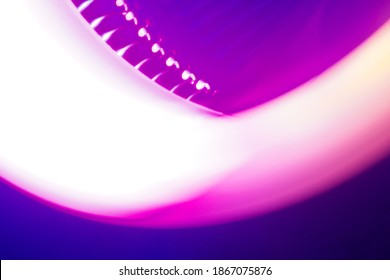 Abstract Blurred background spining fan. glowing lines, neon lights, virtual reality, abstract background, square portal, arch, pink blue spectrum vibrant colors, laser show