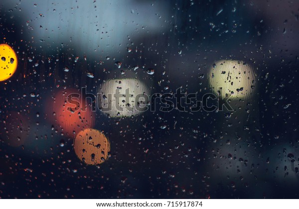 abstract blurred background traffic jam bokeh light view
outside road from inside a car while raining with rain drops on
glass, night cityscape,cinematic photography with film grain style
