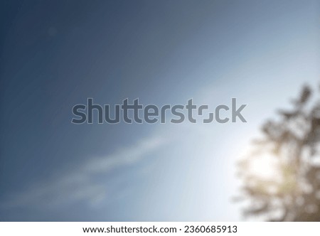 Abstract blurred background with trees and sky. Summer background of blue and green, blurred foilage and sky with bright. Blurry abstract summer background with copy space.