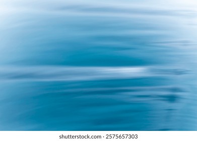 abstract blurred background with white and blue sea waves and sky clouds