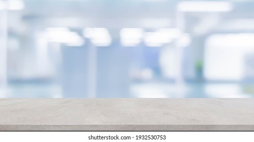 Abstract Blurred Blue Color Of Interior Modern Office Room Background With Perspective Cement Quartz Table For Show, Promote And Design Content Or Product On Display Concept