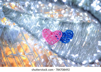 Abstract blurred bokeh and heart background for valentine love concept.Soft focus couple heart sharp hand made with bamboo two color pink and blue in circle bokeh led background with copy space.
