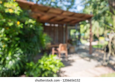 Abstract Blurred Bokeh Outdoor Coffee Shop, Coffeehouse Or Cafe In Green Nature Garden On Day Time Background