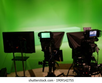 Abstract Blurred Of Broadcast Camera In Studio With Virtual Greenscreen At TV Station.