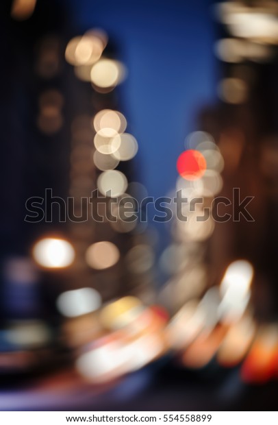 Abstract blurred city\
background. Large city street lights at night. Lights and shadows\
of New York City
