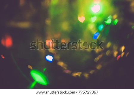 Abstract blurred colorful christmas bokeh background heart shape. Toned, style photo.
