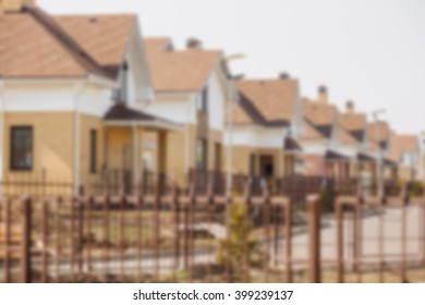 abstract blurred defocused background. Street view on a  row of a new modern residential house complex