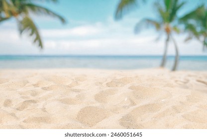 Abstract blurred defocused beach background, nature of tropical summer beach. Golden sand beach, sea water and palms against sky. Summer vacation concept.