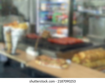 Abstract Blurred And Defocused Cafe Or Restaurant Window Glass With Food And Drinks In The Background