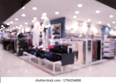 Abstract Blurred Department Clothing Store Interior Background. Blur Aisle Of Supermarket Or Warehouse For Backdrop And Design Element Use. Defocused Background With Bokeh Light.