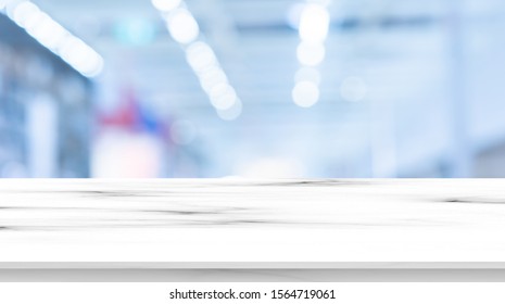 Abstract Blurred Drug Store Aisle Shelf Distribution Background With White Marble Perspective Counter To Show,promote,advertise On Display For Medical Pharmaceutical Business Concept