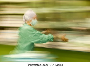 Abstract, Blurred Figure Of Nurse Runing Busy During Operation