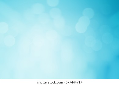 Abstract Blurred Flash Aura Of Blue Background With Bokeh Flare Light.