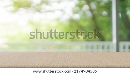 abstract blurred garden view form living room window with concrete table counter background for show , promote ,design banner ads on display concept