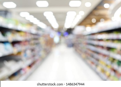 Abstract blurred grocery store interior background. Blur aisle of supermarket, grocery store or warehouse for backdrop and design element use. Defocused background with bokeh light.