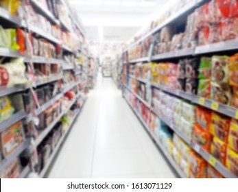 Abstract Blurred Grocery Store Interior Background. Blur Aisle Of Supermarket, Grocery Store Or Warehouse For Backdrop And Design Element Use. Defocused Background With Bokeh Light.