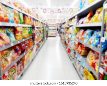 Abstract Blurred Grocery Store Interior Background. Blur Aisle Of Supermarket, Grocery Store Or Warehouse For Backdrop And Design Element Use. Defocused Background With Bokeh Light.