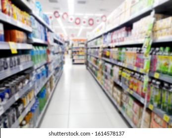 Abstract Blurred Grocery Store Interior Background. Blur Aisle Of Supermarket, Grocery Store Or Warehouse For Backdrop And Design Element Use. Defocused Background With Bokeh Light.