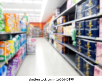 Abstract Blurred Grocery Store Interior Background. Blur Aisle Of Supermarket, Grocery Store Or Warehouse For Backdrop And Design Element Use. Defocused Background With Bokeh Light.