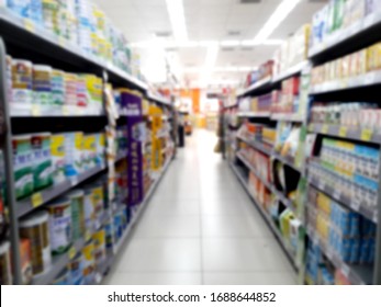 Abstract Blurred Grocery Store Interior Background. Blur Aisle Of Supermarket, Grocery Store Or Warehouse For Backdrop And Design Element Use. Defocused Background With Bokeh Light.