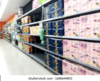 Abstract Blurred Grocery Store Interior Background. Blur Aisle Of Supermarket, Grocery Store Or Warehouse For Backdrop And Design Element Use. Defocused Background With Bokeh Light.