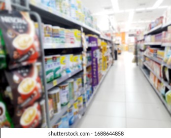 Abstract Blurred Grocery Store Interior Background. Blur Aisle Of Supermarket, Grocery Store Or Warehouse For Backdrop And Design Element Use. Defocused Background With Bokeh Light.