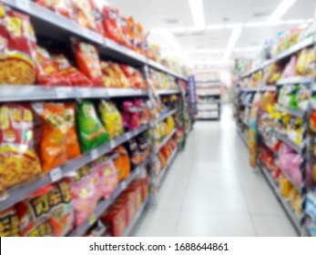 Abstract Blurred Grocery Store Interior Background. Blur Aisle Of Supermarket, Grocery Store Or Warehouse For Backdrop And Design Element Use. Defocused Background With Bokeh Light.