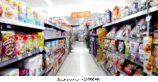 Abstract Blurred Grocery Store Interior Background. Blur Aisle Of Supermarket, Grocery Store Or Warehouse For Backdrop And Design Element Use. Defocused Background With Bokeh Light.