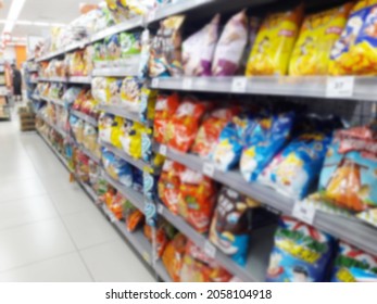 Abstract Blurred Grocery Store Interior Background. Blur Aisle Of Supermarket, Grocery Store Or Warehouse For Backdrop And Design Element Use. Defocused Background With Bokeh Light.