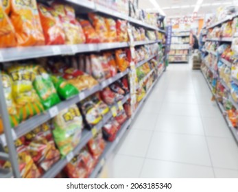 Abstract Blurred Grocery Store Interior Background. Blur Aisle Of Supermarket, Grocery Store Or Warehouse For Backdrop And Design Element Use. Defocused Background With Bokeh Light.