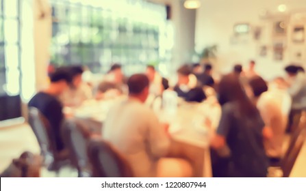 abstract blurred group of asian casual family meeting in the restaurant background at night.
